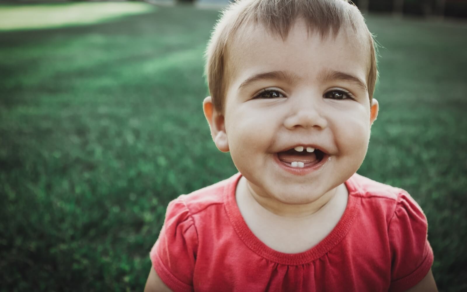 smiling girl baby teeth