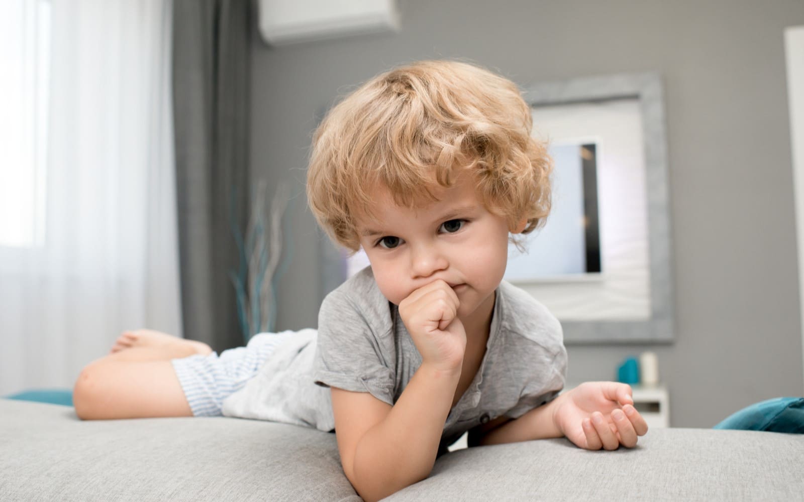 adorable little boy thumb sucking