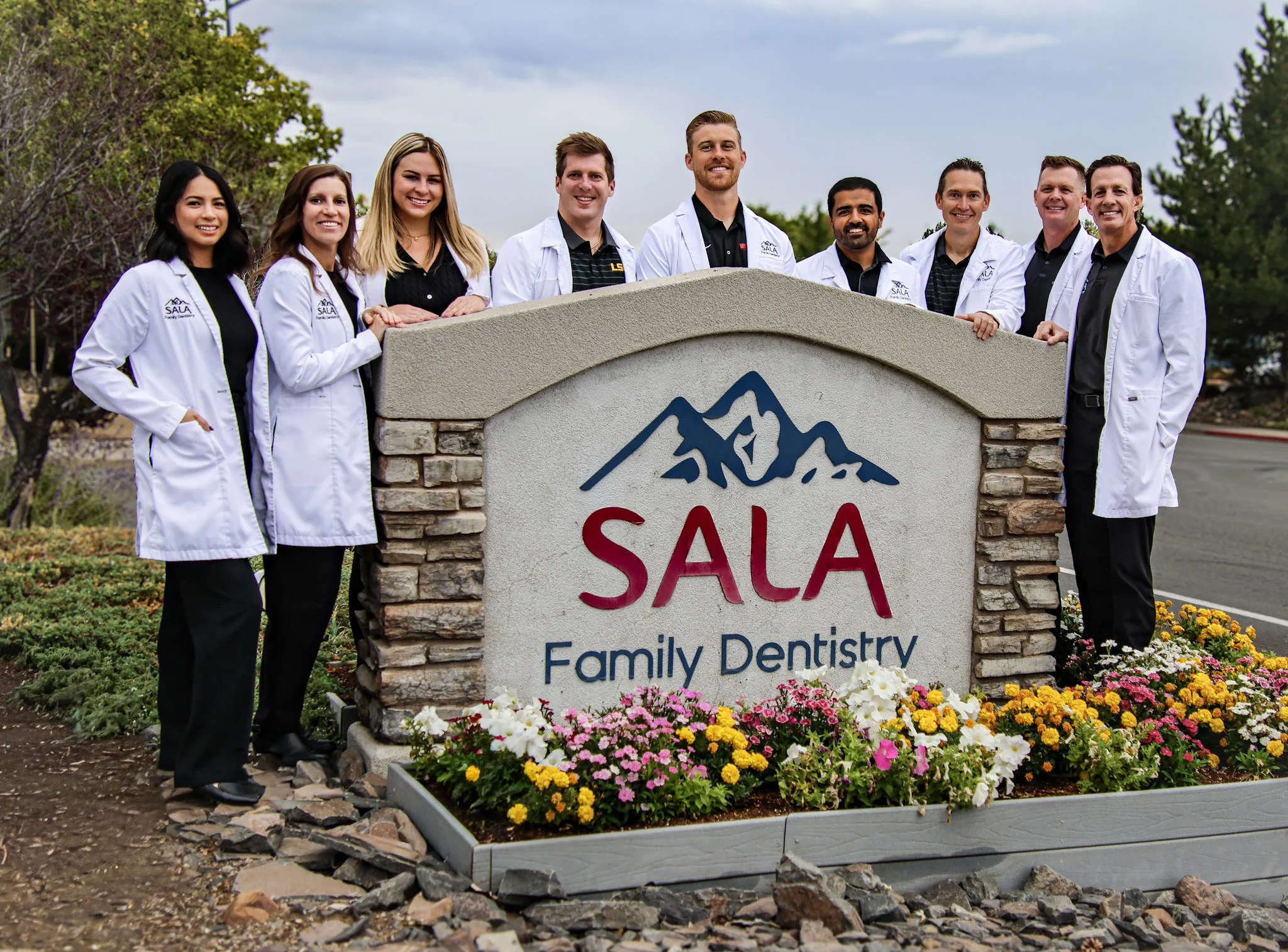 dentist group shot with sign 2025